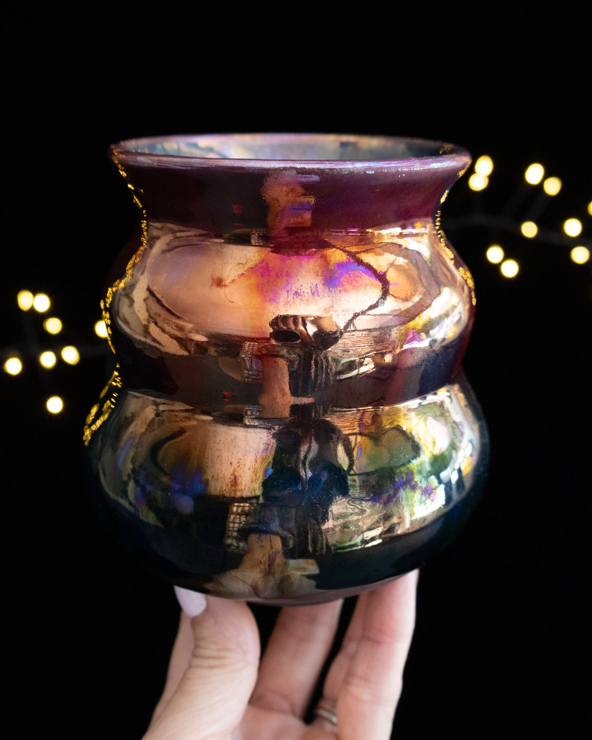 Iridescent in-glaze luster banding down a wheel thrown porcelain vase
