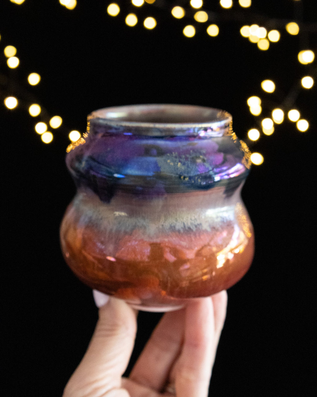 Wheel thrown porcelain vase in copper and violet in-glaze luster