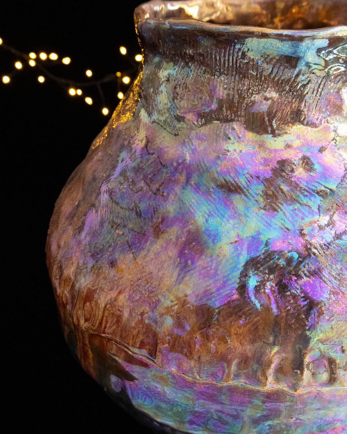 Close detail of pink and teal luster over coiled stoneware