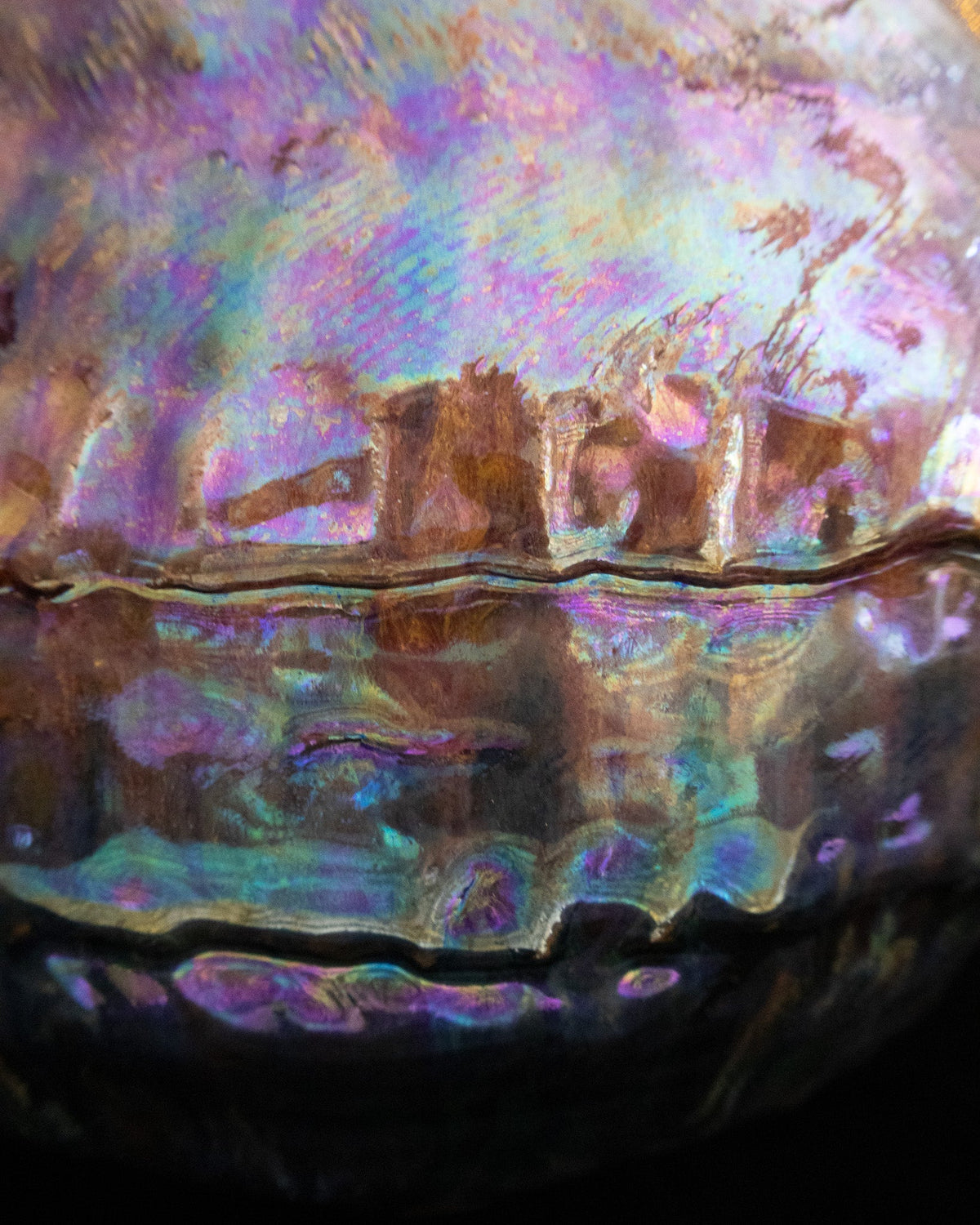 Close detail of iridescent violet and green on hand built stoneware