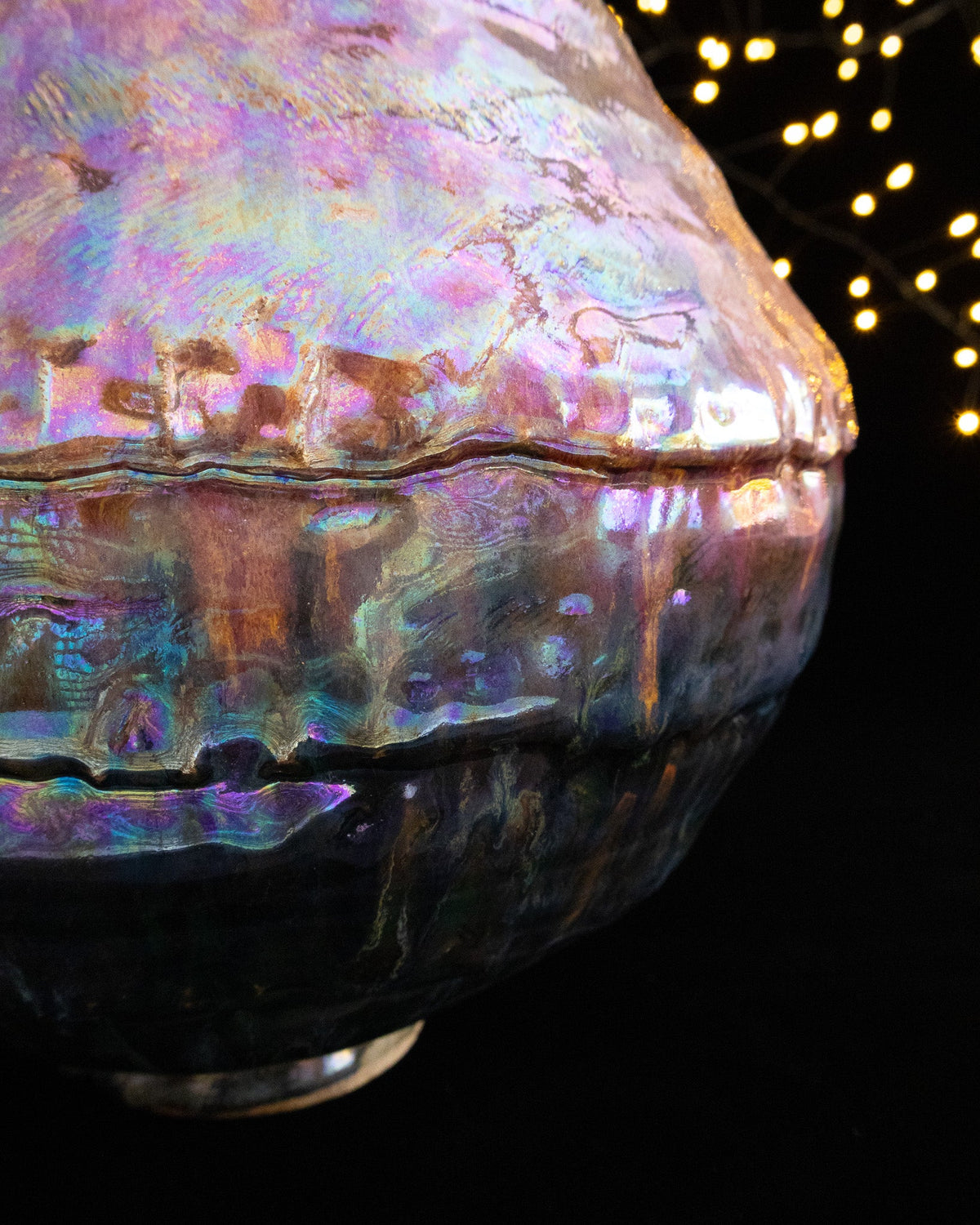 Close detail of warm amber luster on a coiled ceramic surface