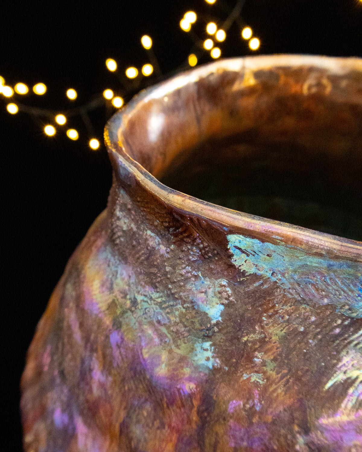 Looking into the wide mouth of a large hand built pot