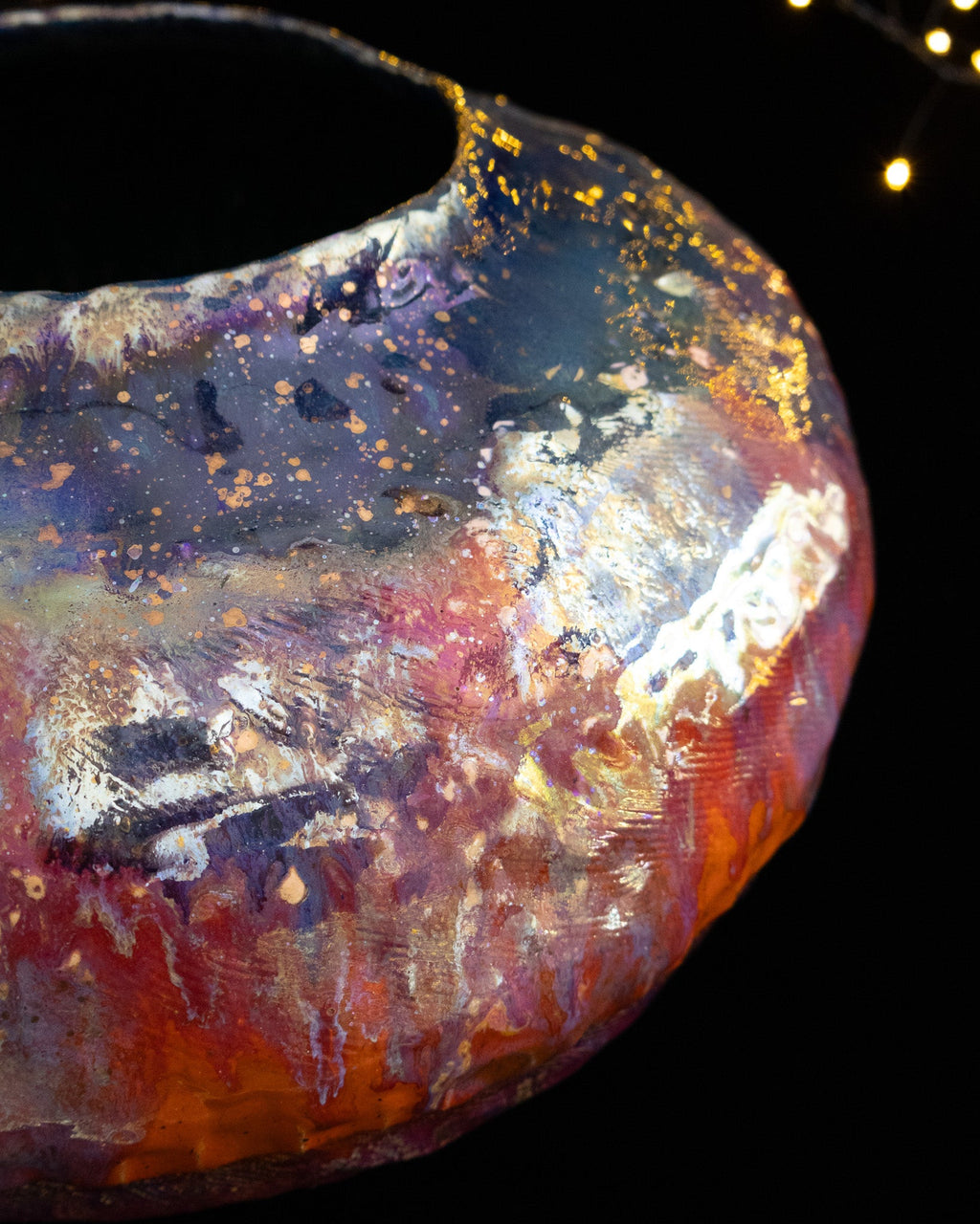 Angled view of a large lusterware pot showing the narrow mouth