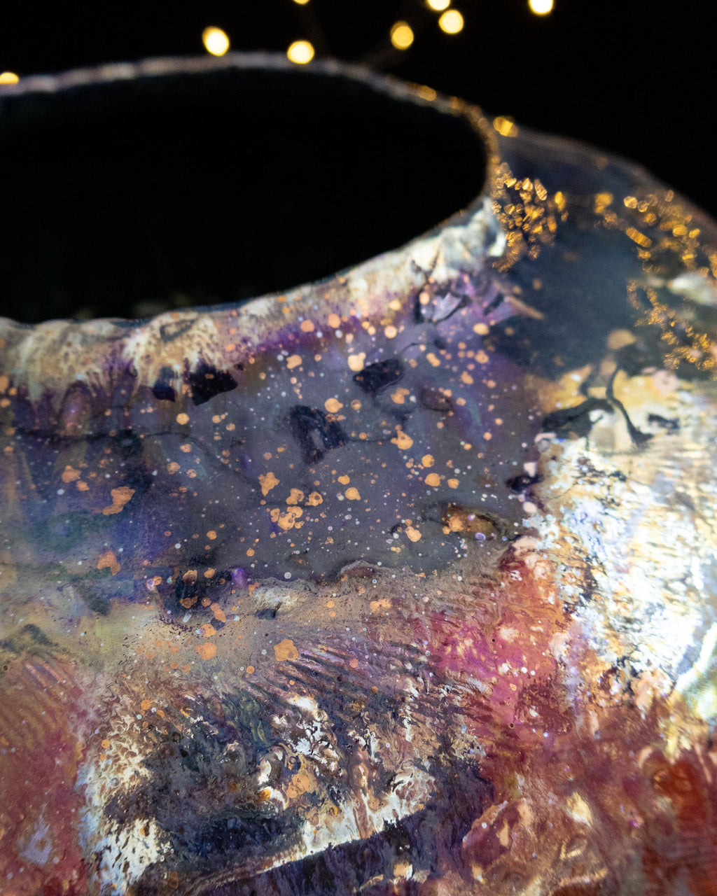 Close detail of silver and crimson luster on a large pot