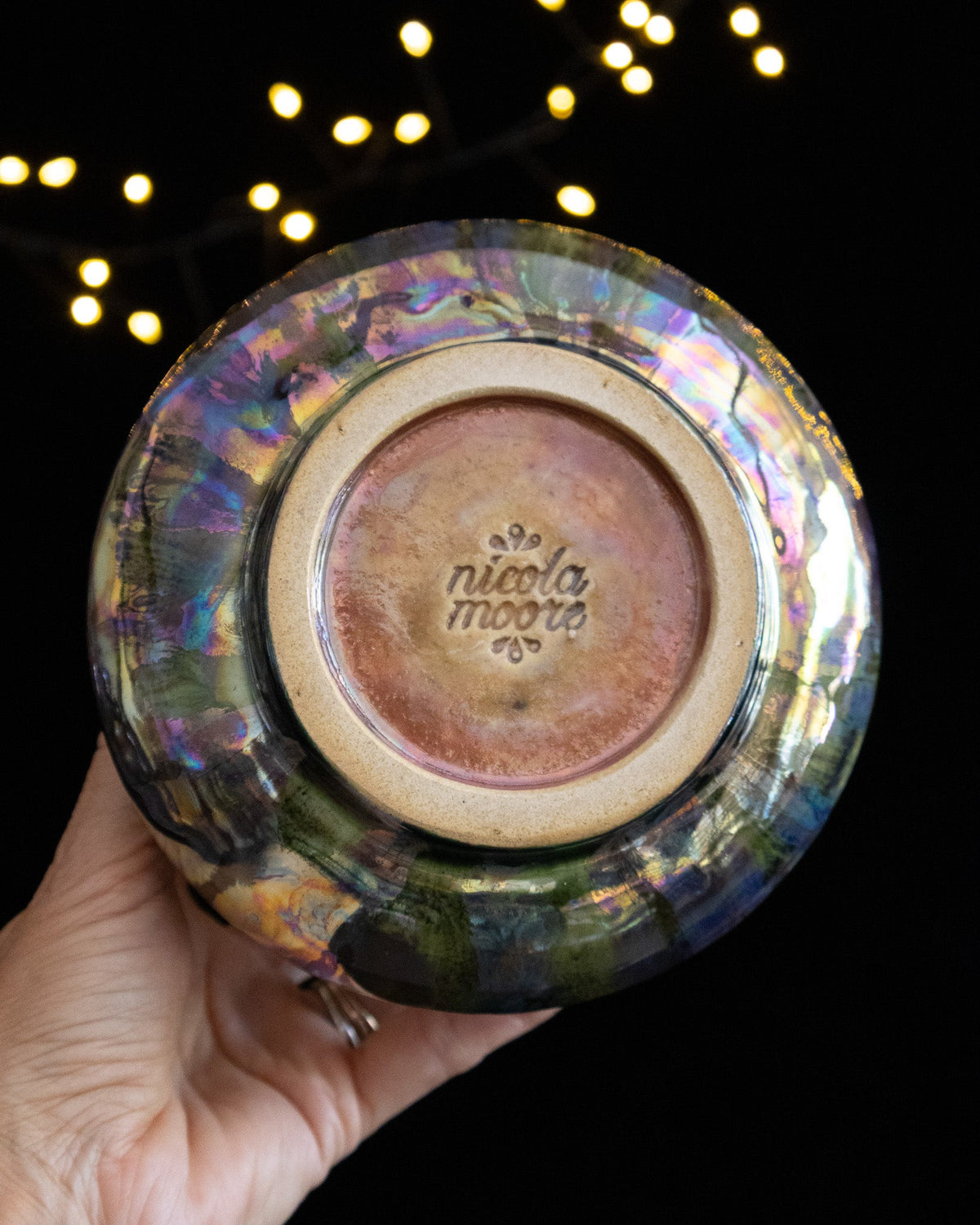Base of a handmade lusterware vase showing the maker's stamp
