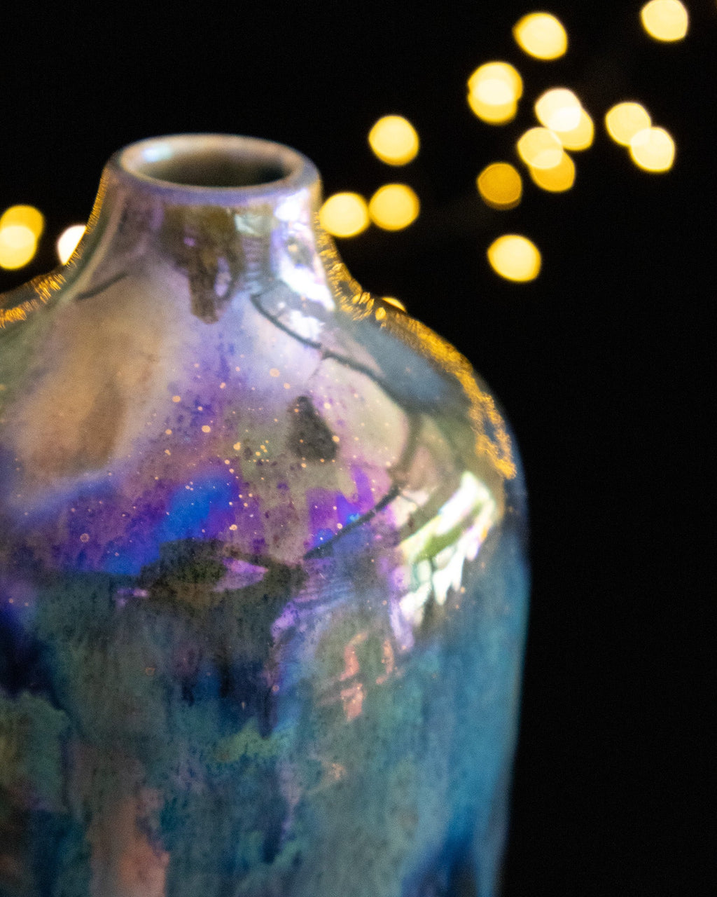 Close detail of iridescent luster on the shoulder of a ceramic bottle