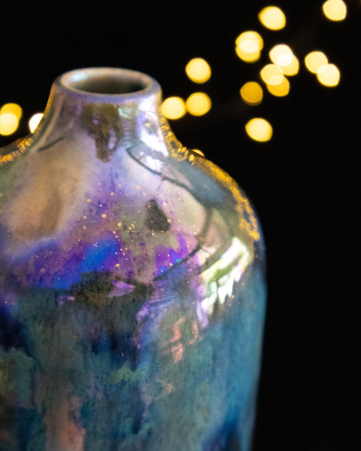 Close detail of iridescent luster on the shoulder of a ceramic bottle
