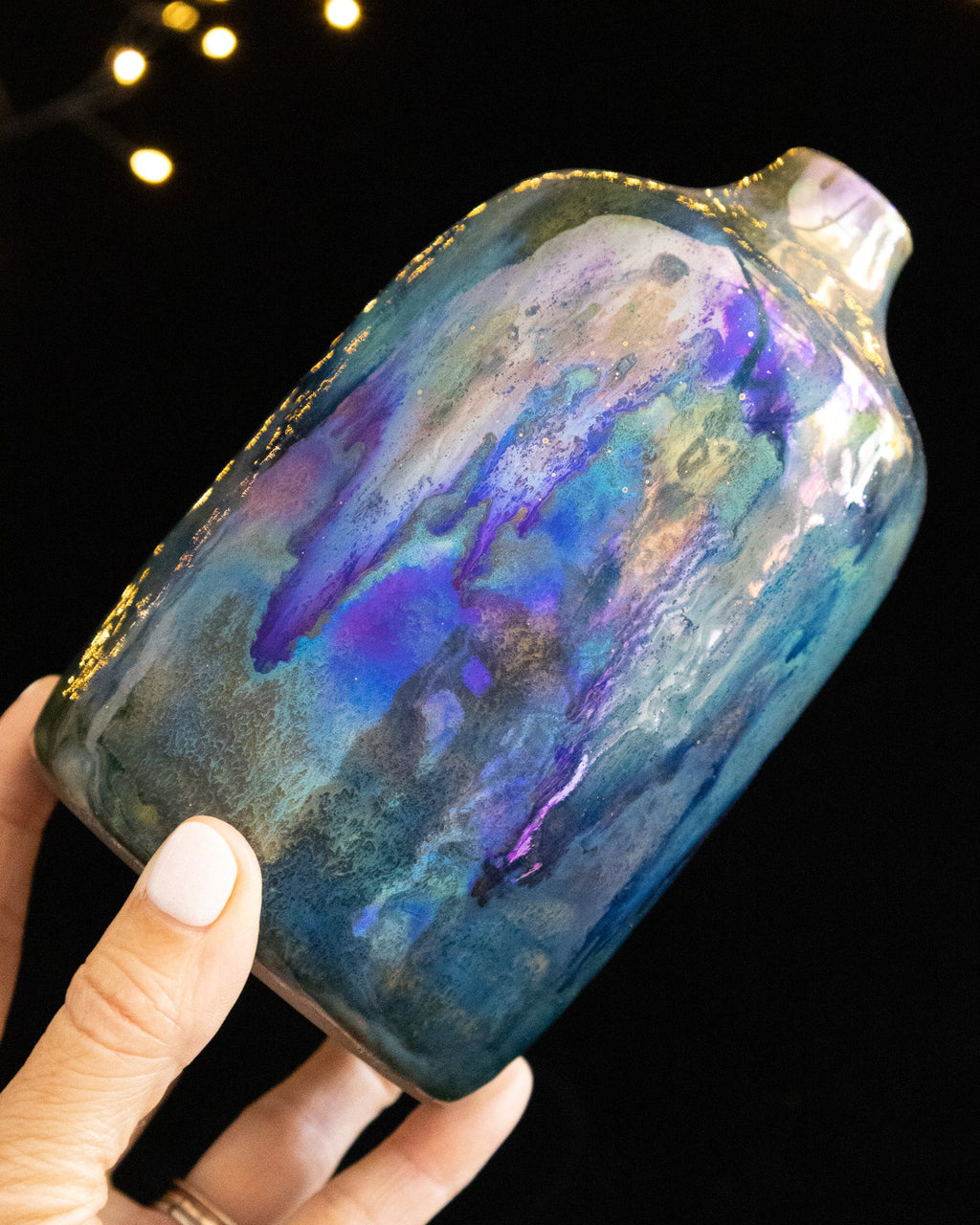 Angled view of a handmade lusterware daydream bottle