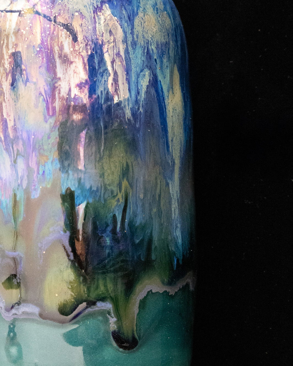 Iridescent violet and turquoise in-glaze luster on a handmade bottle