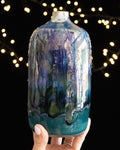 Hand thrown porcelain bottle with a turquoise band around the foot