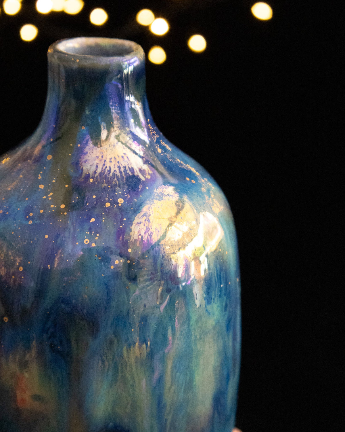 Close detail of the neck and shoulder of a lusterware bottle