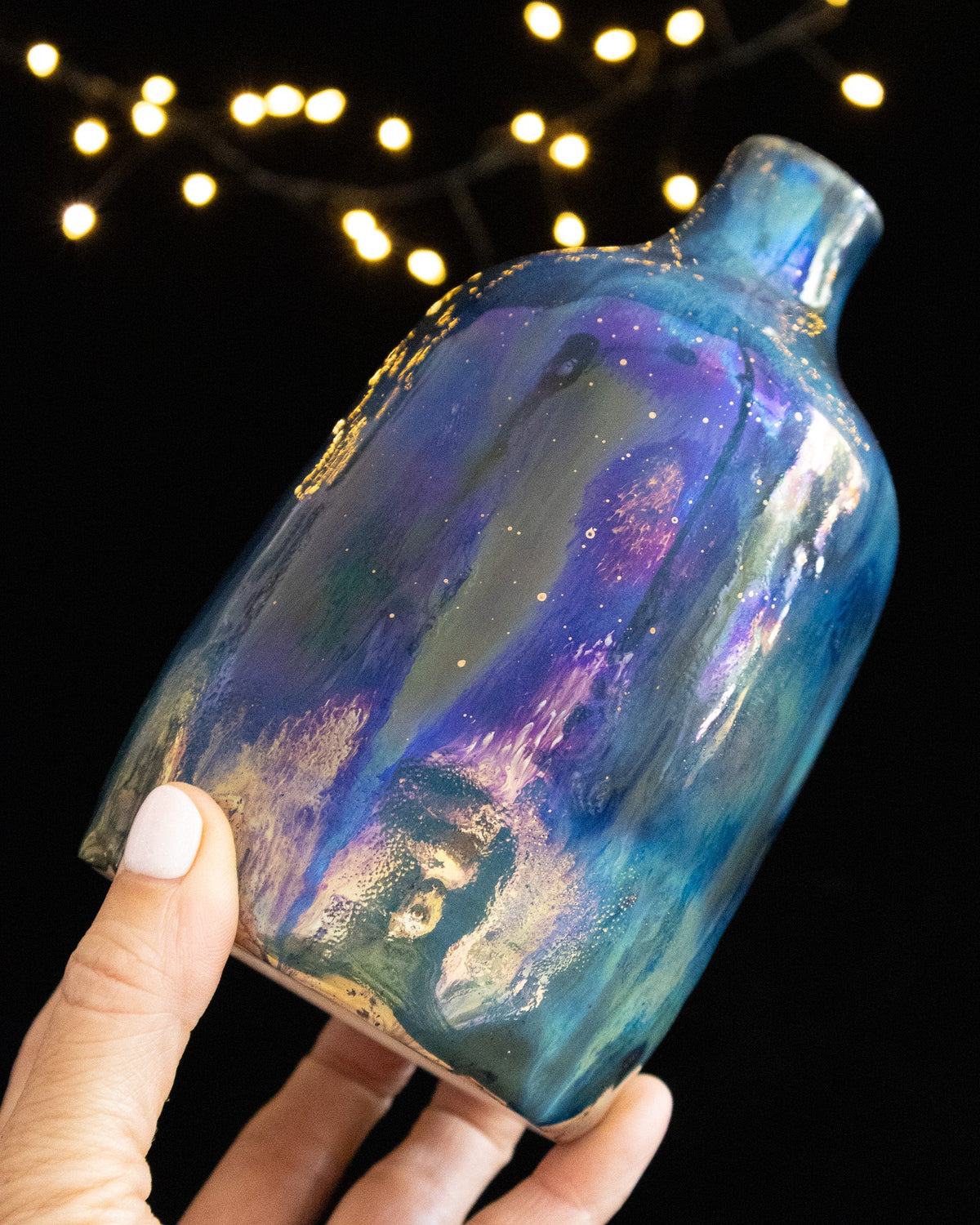 Angled view of a starry blue lusterware bottle