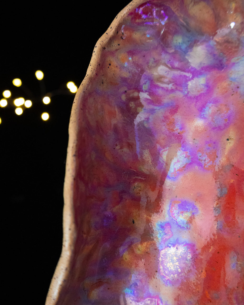 Close detail of iridescent pink luster on handmade stoneware