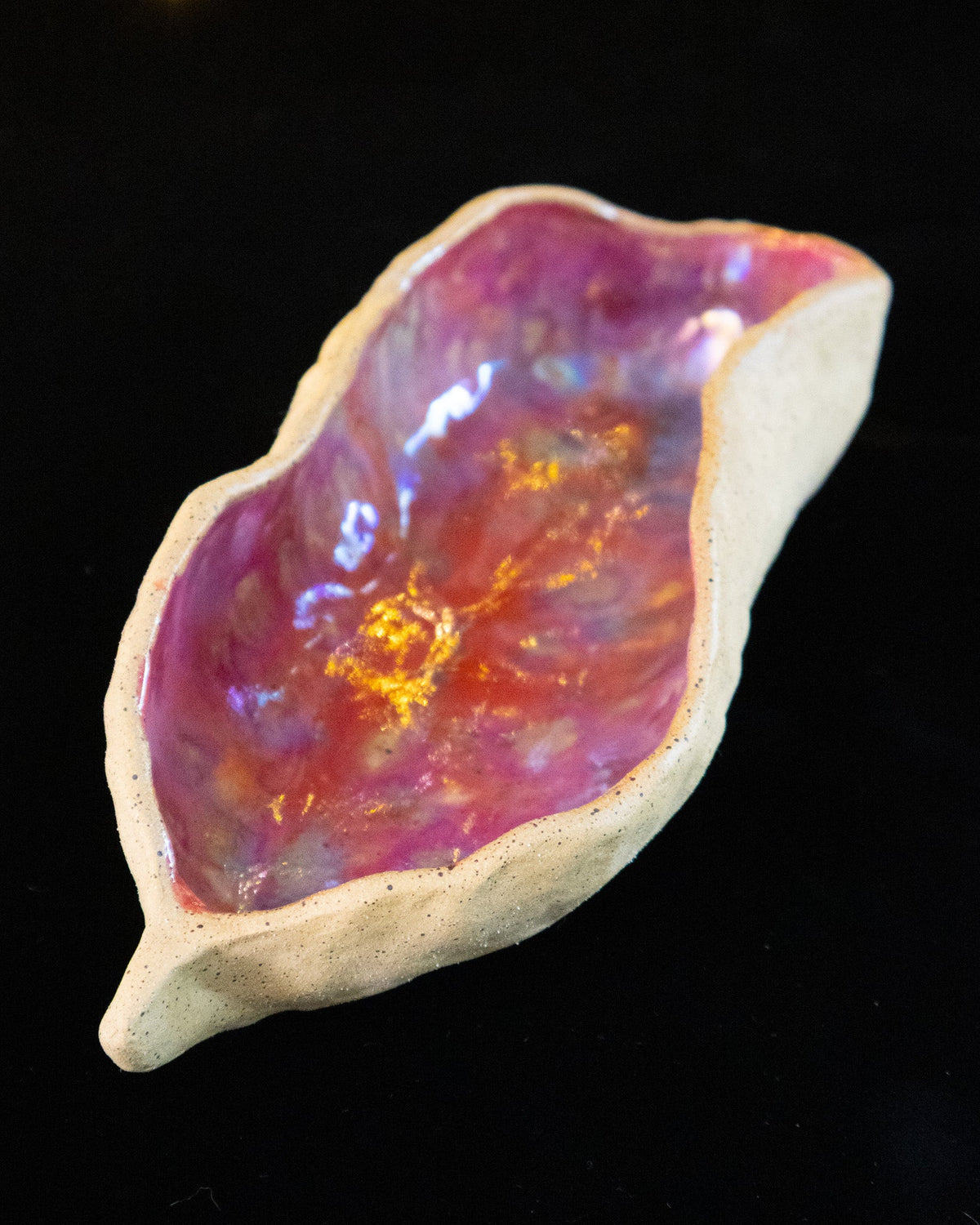 Angled view of a lusterware star seed showing the pinched rim