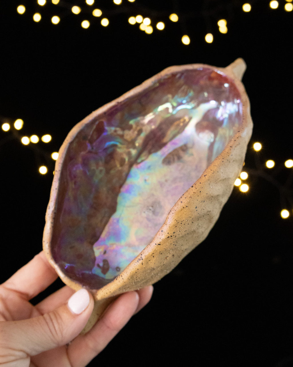 Hand pinched stoneware star seed pod with a pearled violet and rose luster interior