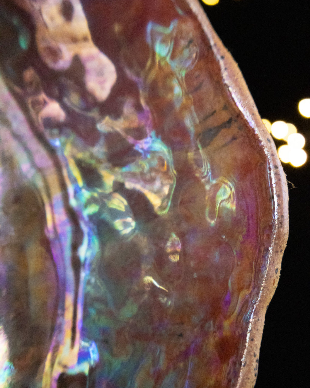 Close detail of shell-like iridescent sheen on handmade stoneware