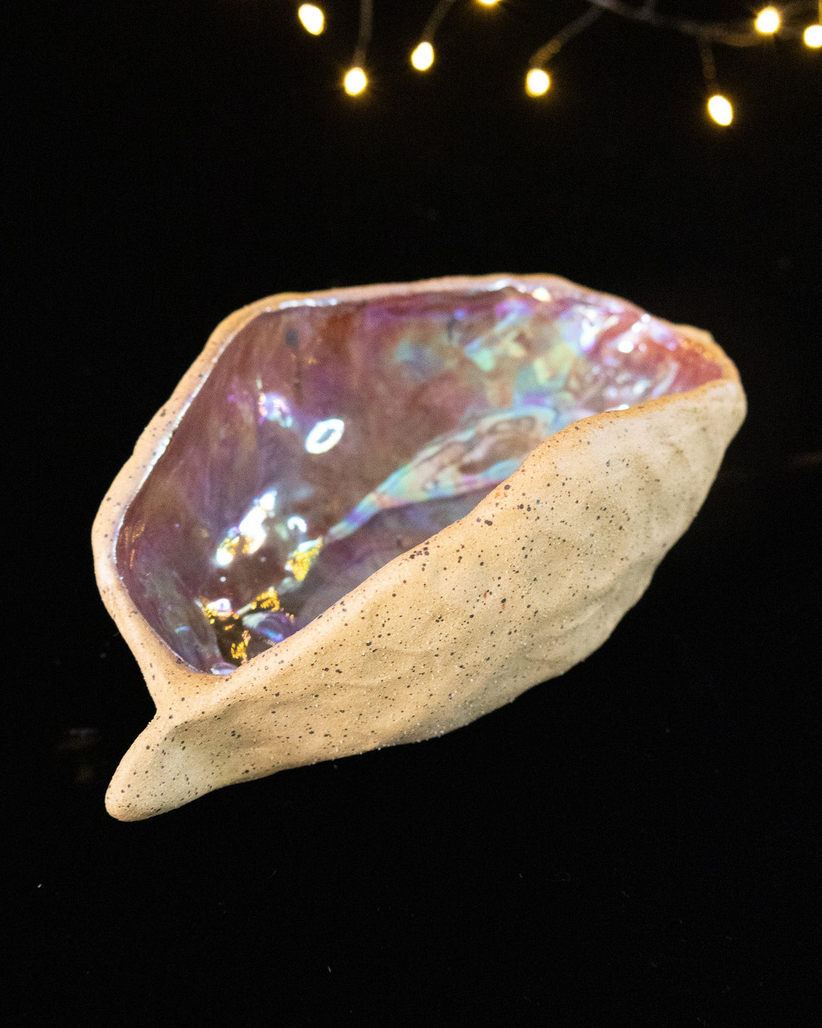 Angled view of a handmade lusterware star seed