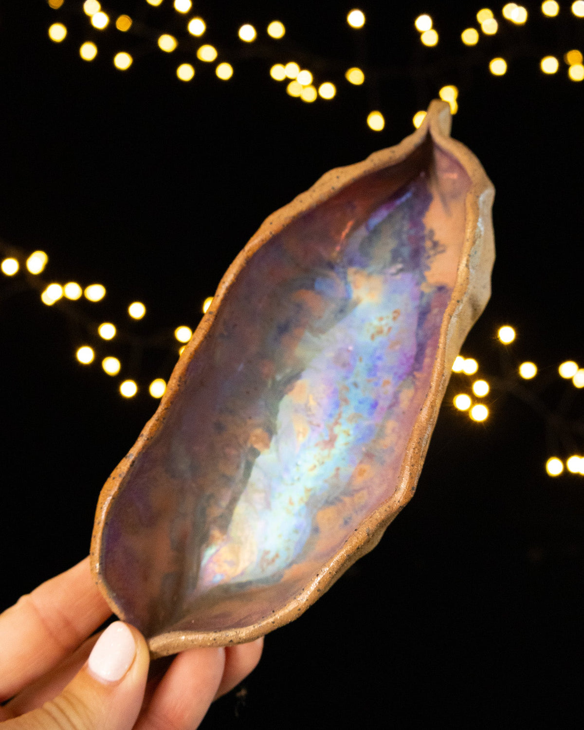 Angled view of a handmade lusterware star seed