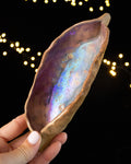Hand pinched stoneware star seed pod with a violet and rose luster interior