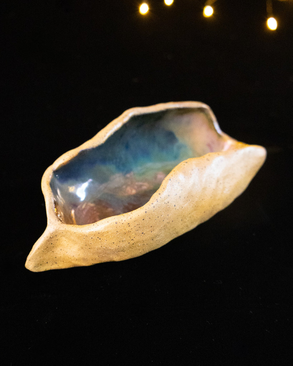 Angled view of a handmade lusterware star seed