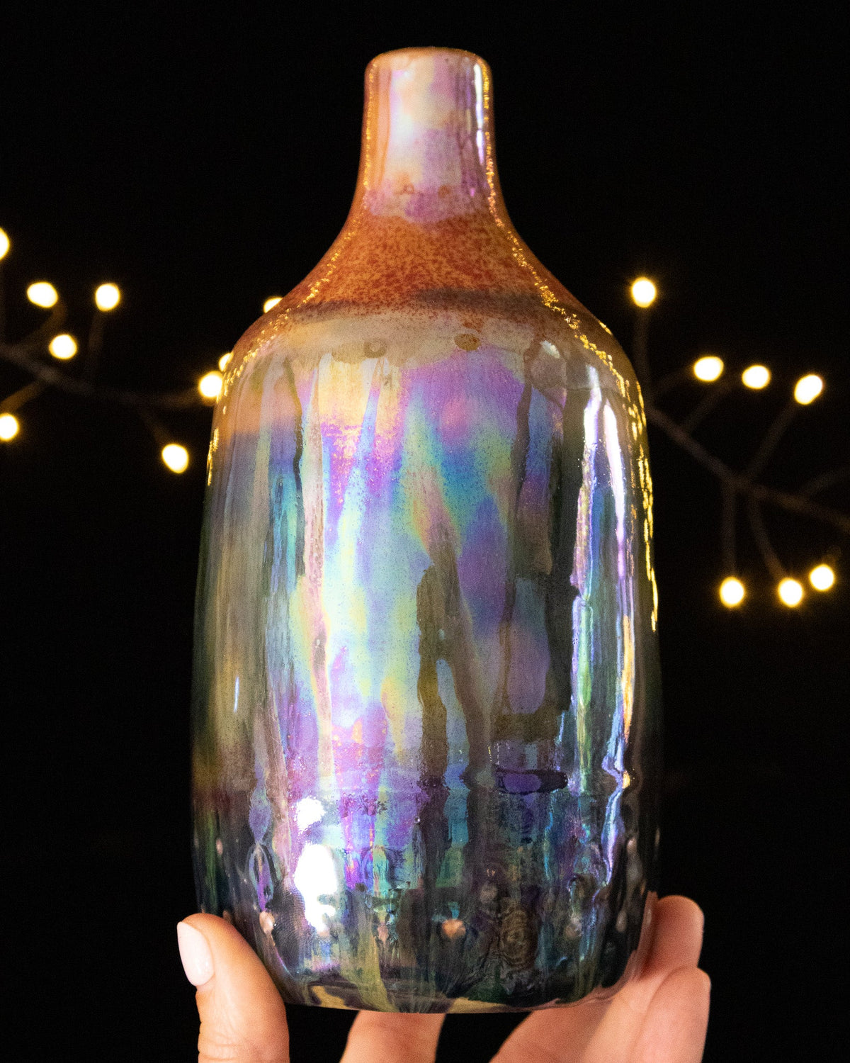 Handmade lusterware daydream bottle with warm rust shoulder and rainbow sheen