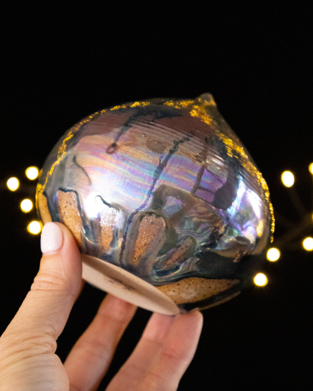 Underside and foot of a handmade balance bulb sound sculpture