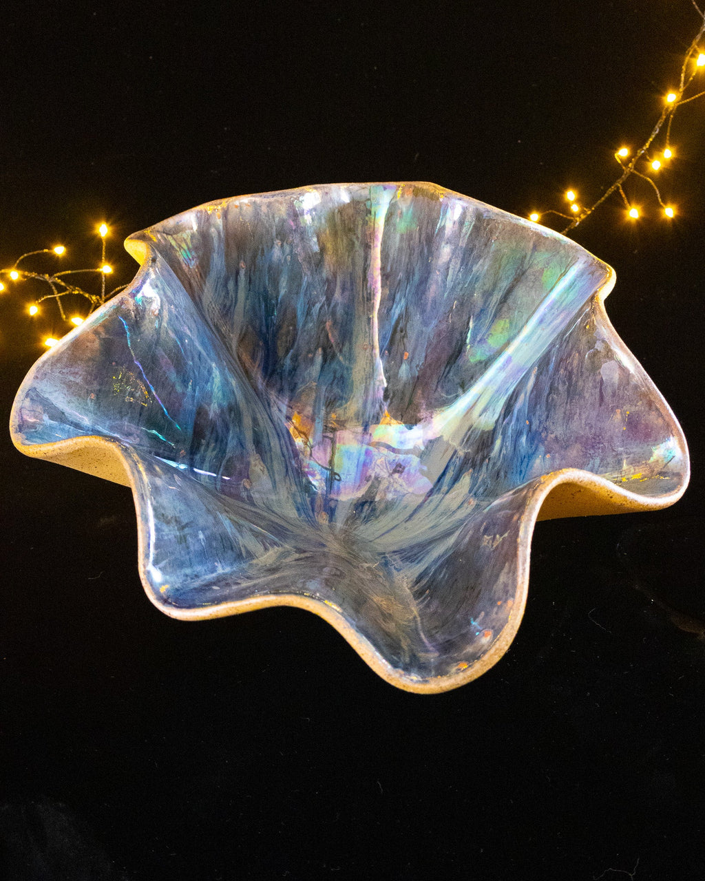 Silver and blue rays running out from the centre of a lusterware bloom