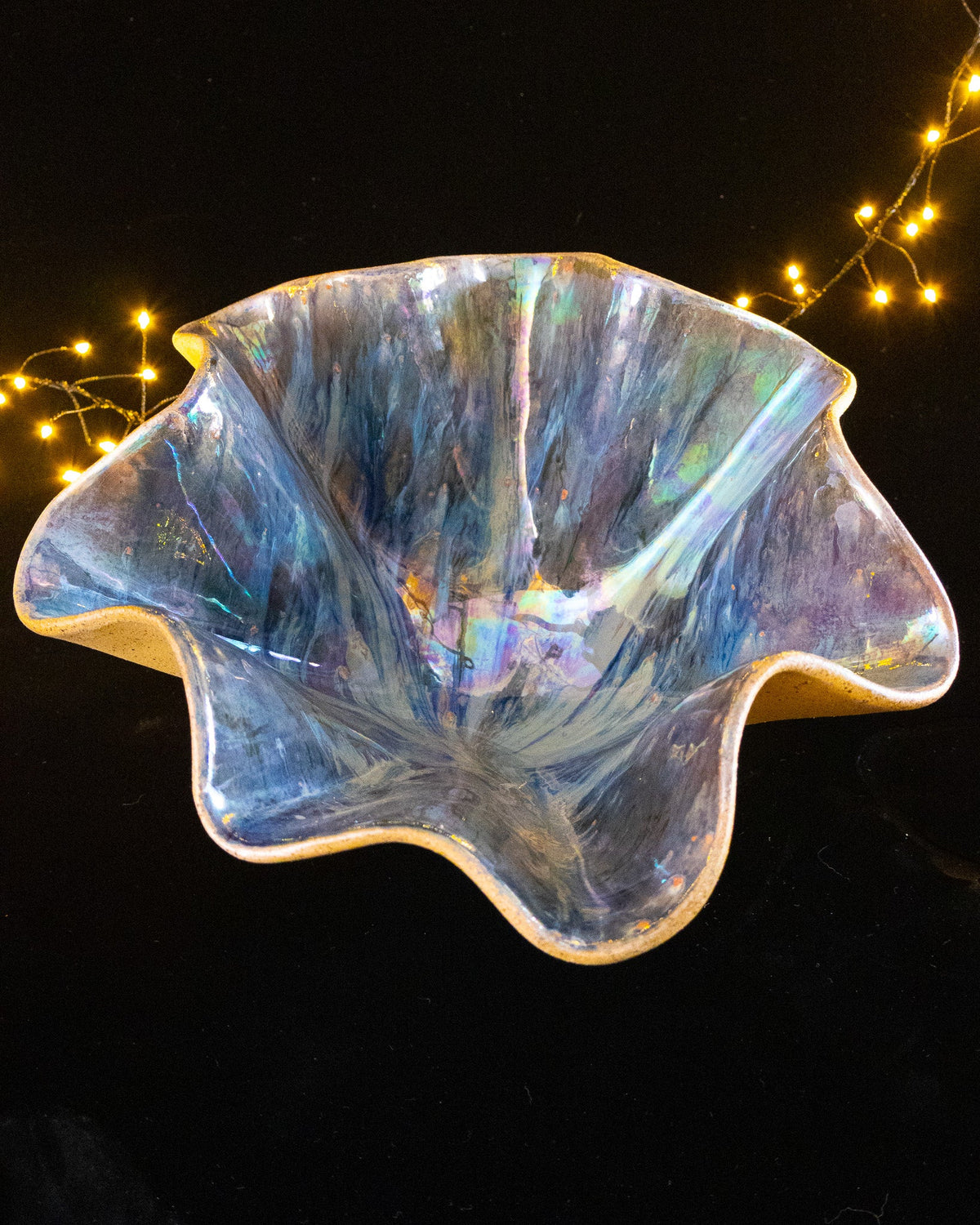 Silver and blue rays running out from the centre of a lusterware bloom