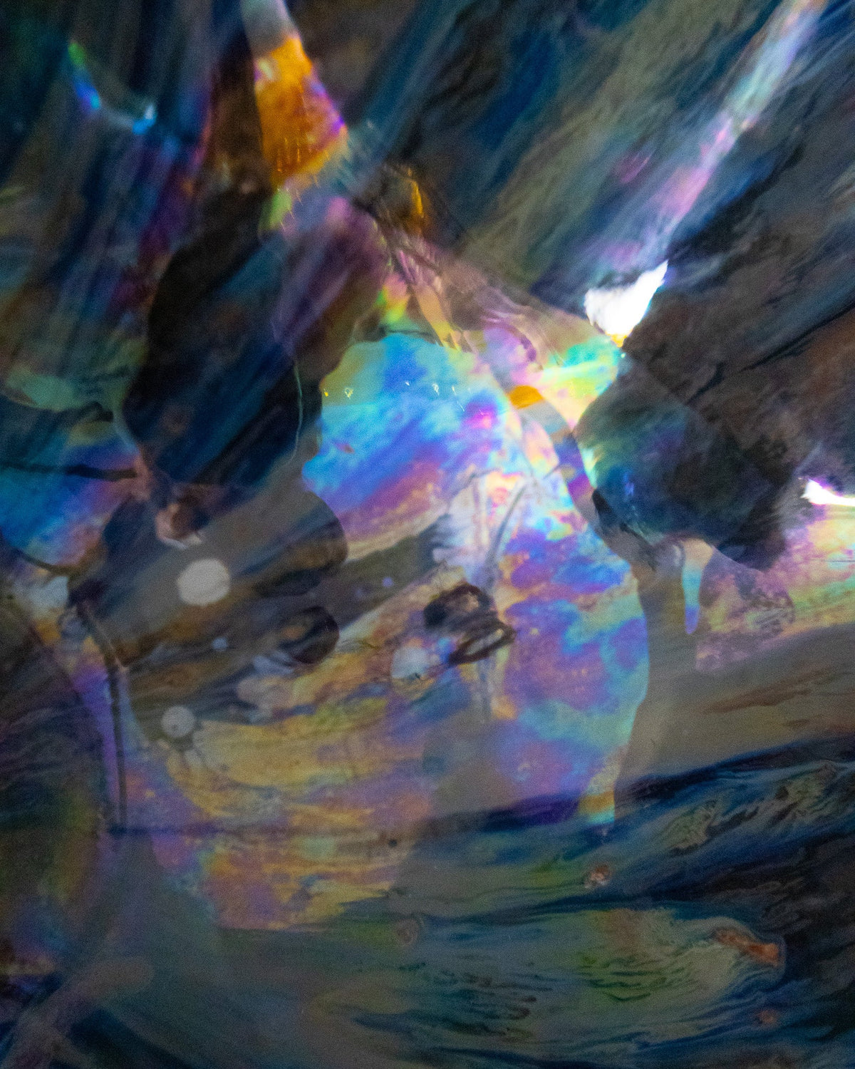 Close detail of iridescent rays on a ruffled ceramic bloom