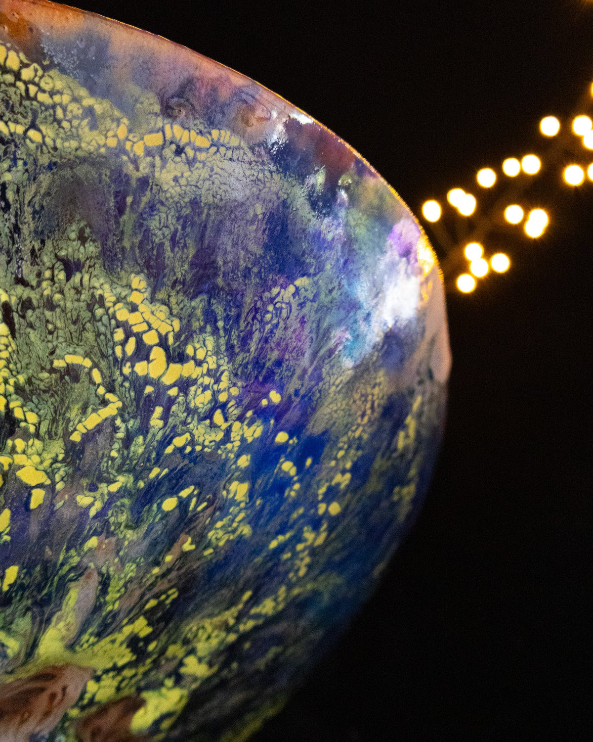 Close view of chartreuse drifting across deep blue in-glaze luster
