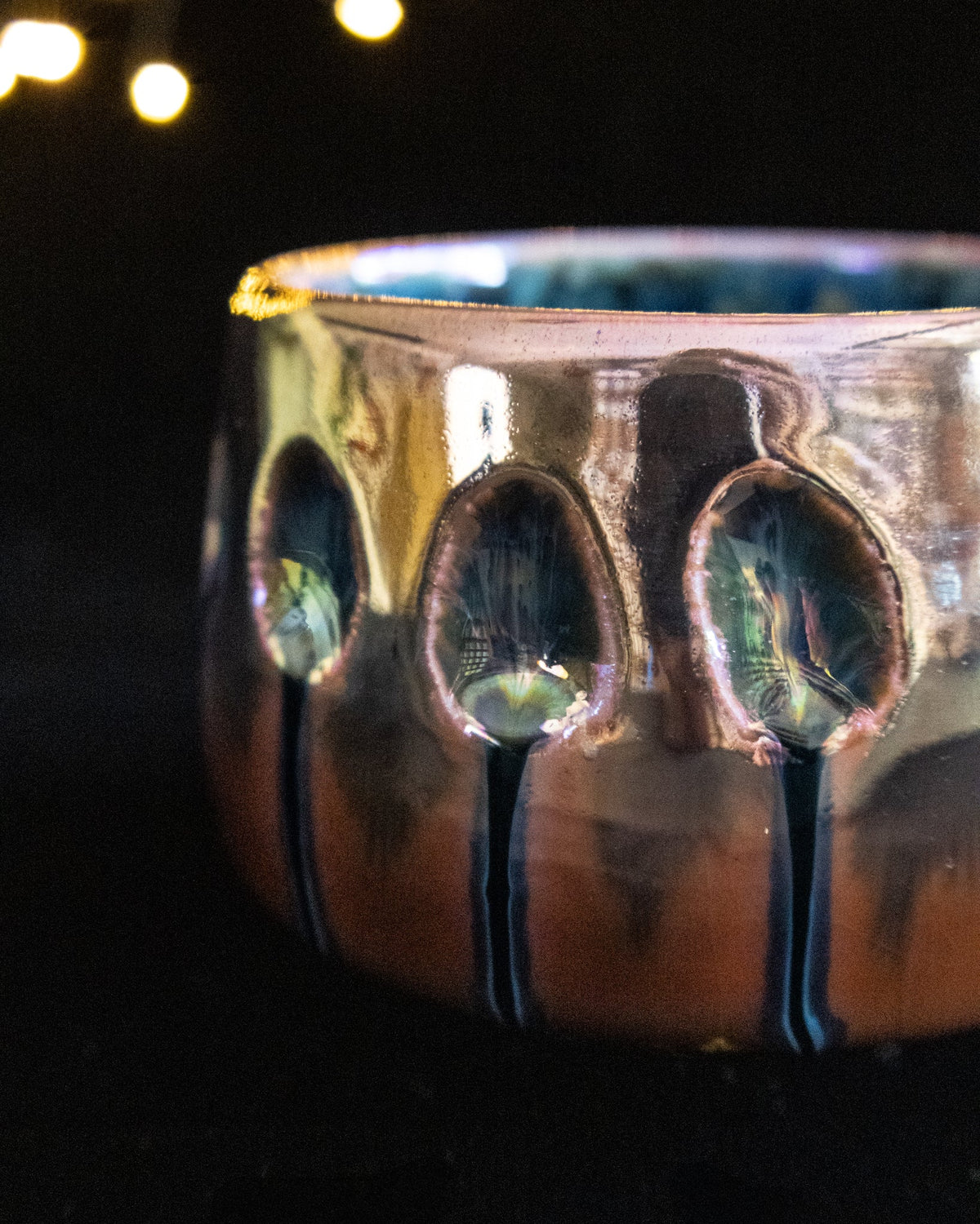 Close detail of oval impressions in amber luster glaze