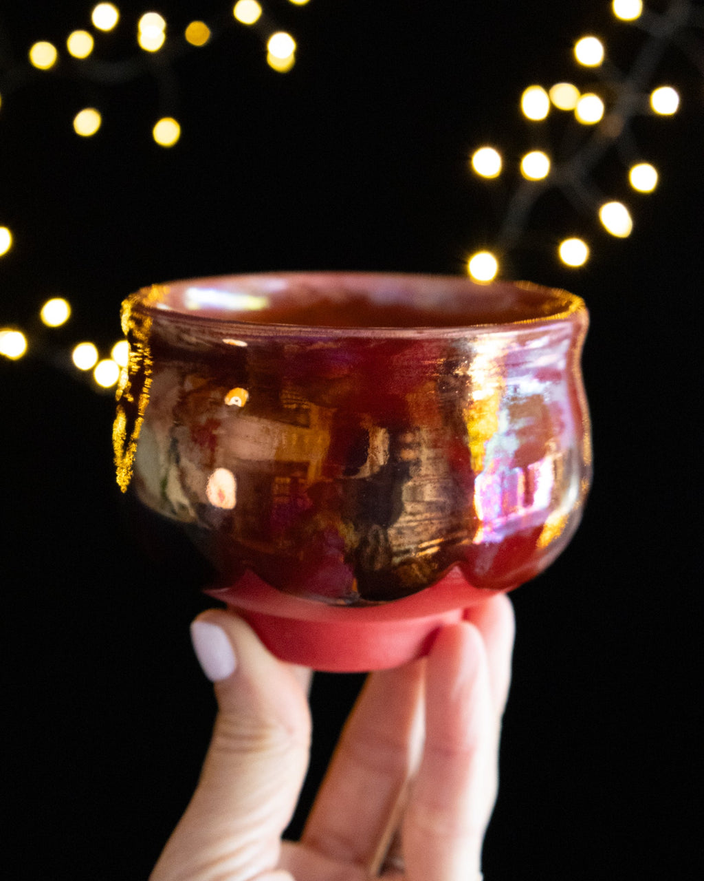 Deep garnet in-glaze luster with a purple blush on wheel thrown porcelain
