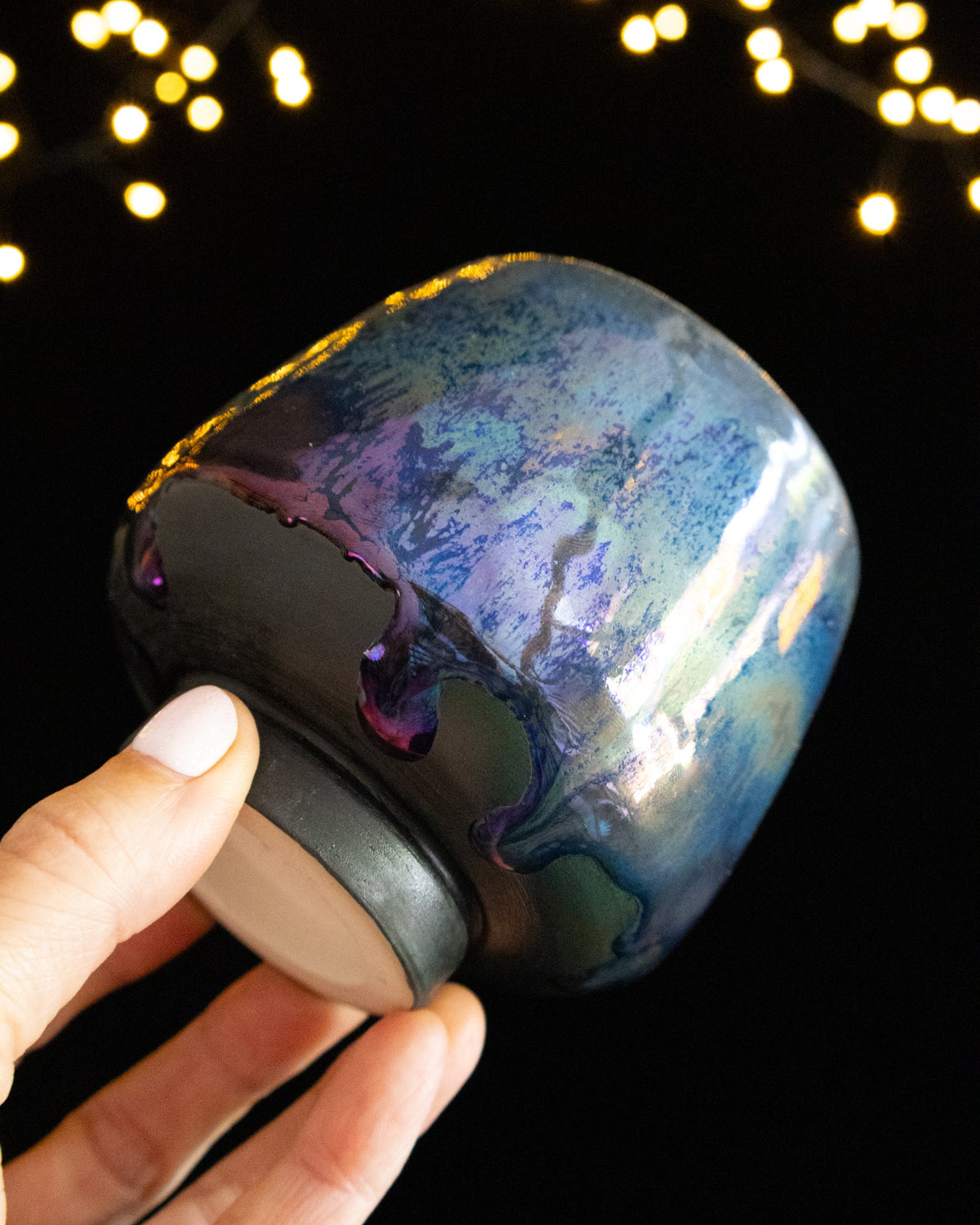 Close detail of iridescent teal and violet luster glaze