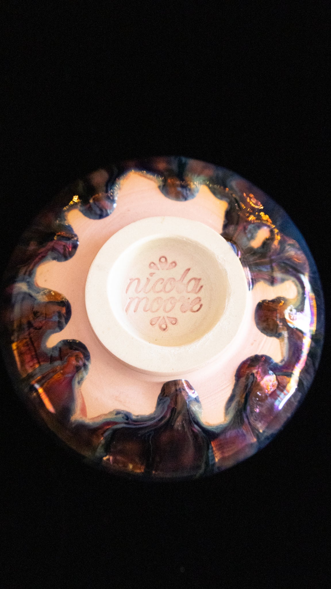 Base of a handmade lusterware ritual cup showing the maker's stamp