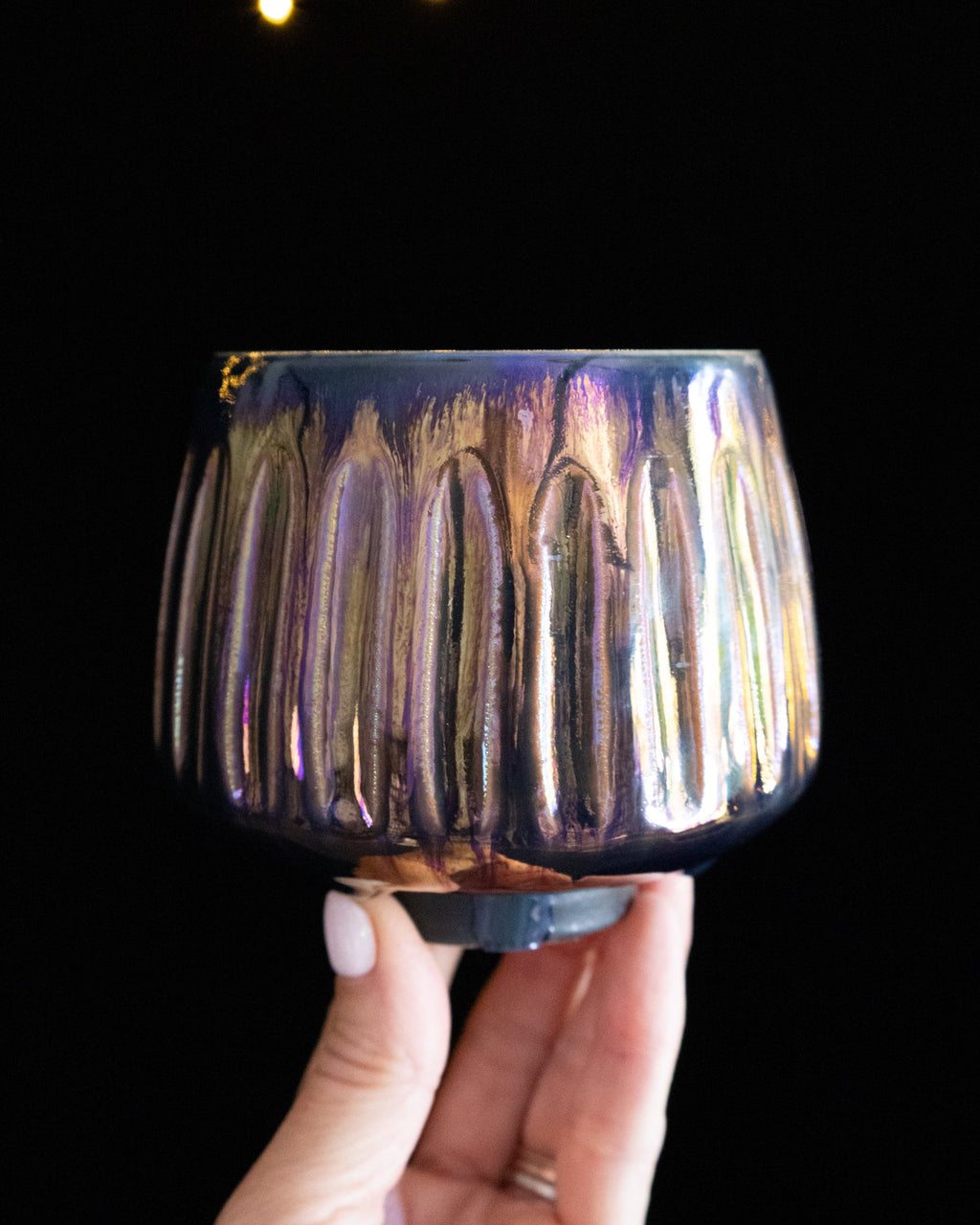 Violet and blue in-glaze luster on a fluted wheel thrown cup