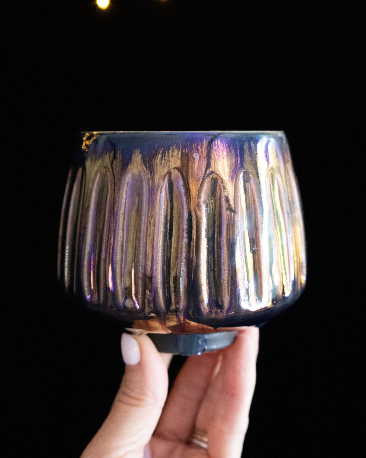 Violet and blue in-glaze luster on a fluted wheel thrown cup