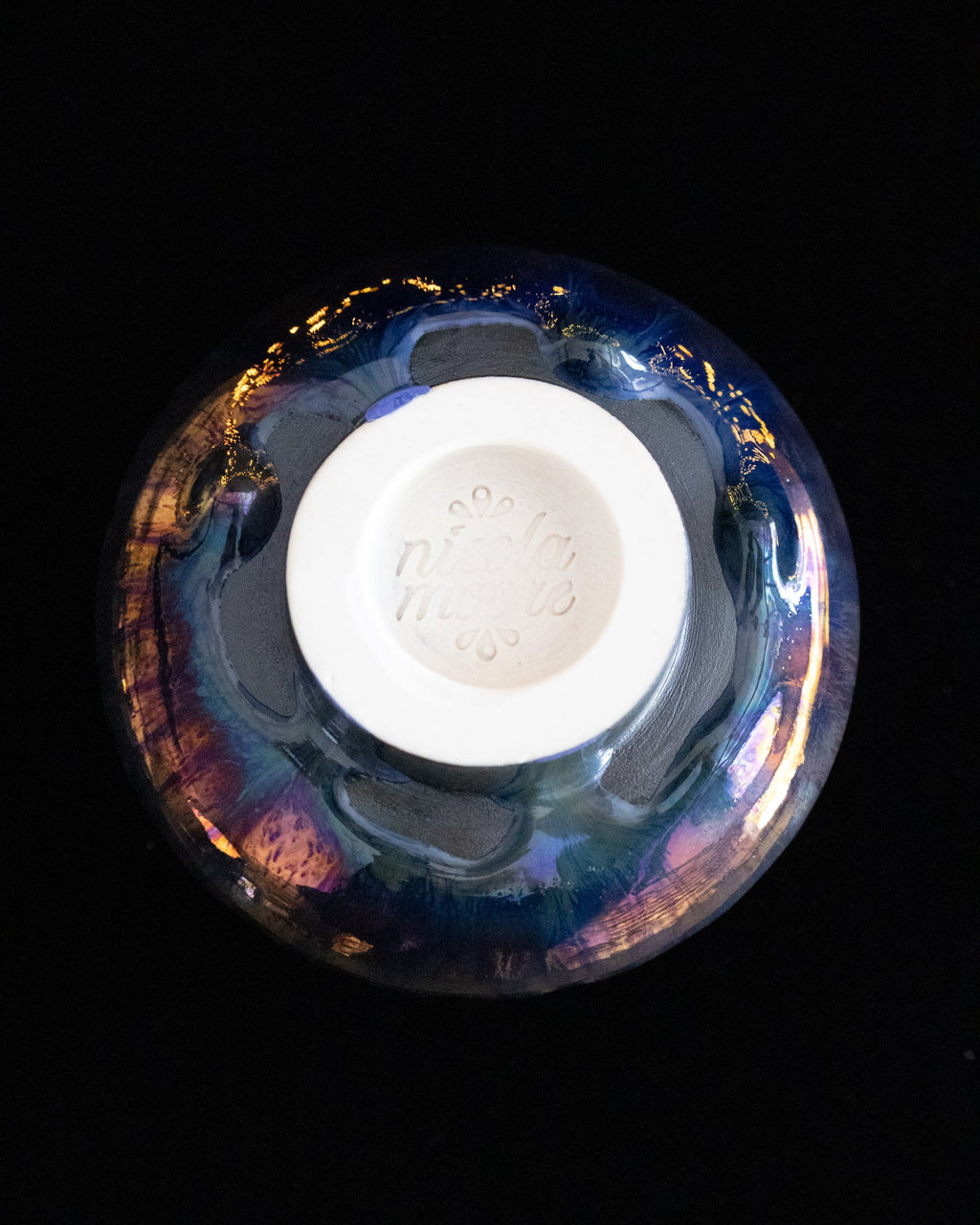 Underside of a handmade fluted lusterware cup
