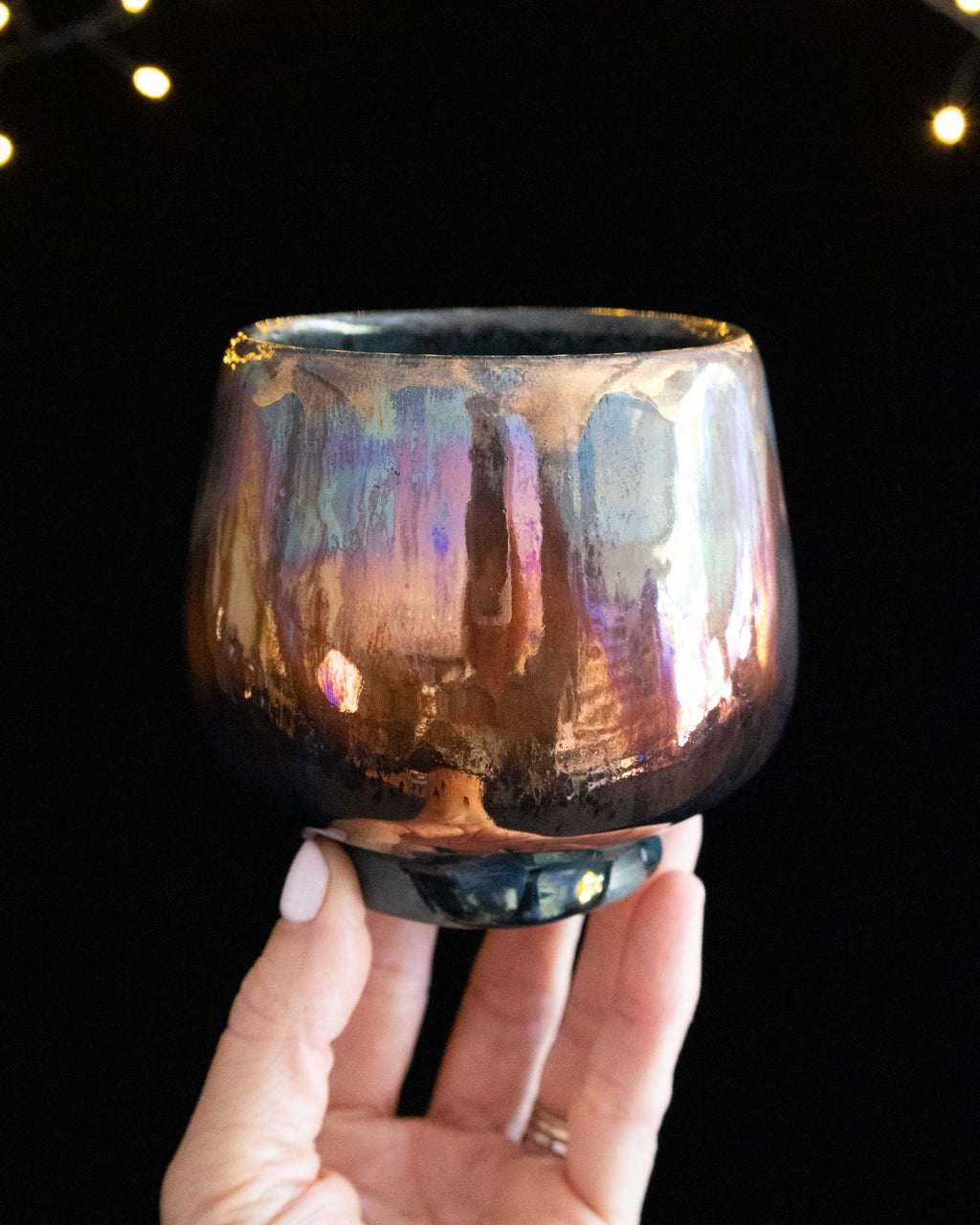 Wheel thrown porcelain cup with iridescent rose luster glaze