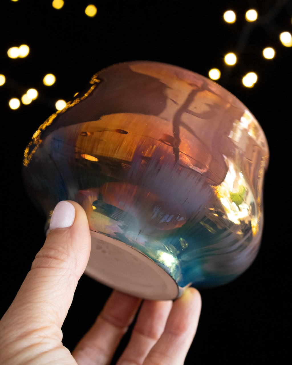 Angled view of an amber lusterware ritual cup showing the foot