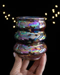Handmade lusterware curvy cup with three stacked curves in rainbow iridescence